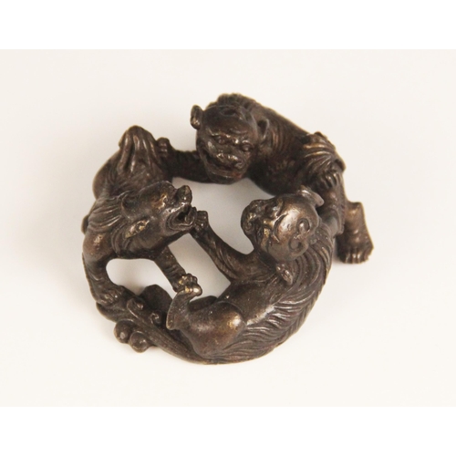 391 - A Chinese bronze group of three Shi Shi, 20th century, modelled in circular form supporting a glass ... 