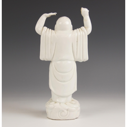 423 - A Chinese Blanc de chine porcelain figure of Buddha, 19th century, modelled standing with arms aloft... 