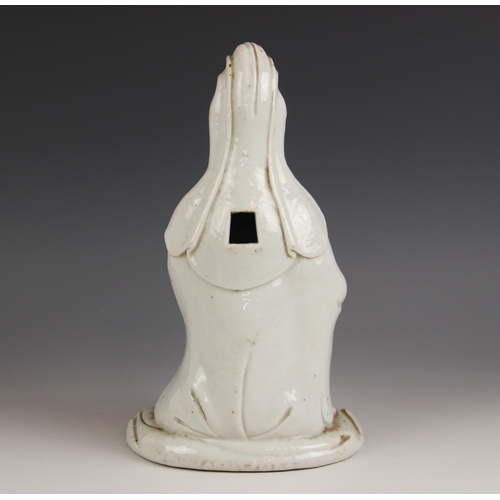 424 - A Chinese Blanc de chine porcelain figure of Guanyin, 19th century, modelled kneeling and wearing a ... 