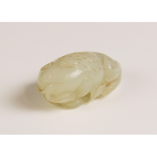 427 - A Chinese pale jade toad, 19th century, the celadon coloured carving modelled grasping a fruiting vi... 