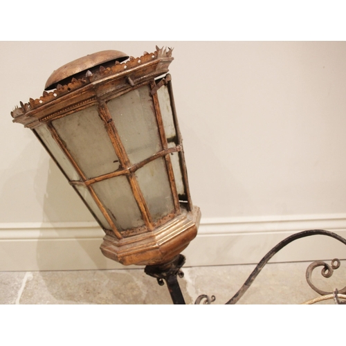 531 - A copper hanging wall lantern, early 20th century, of tapering octagonal pagoda form, the twin panel... 