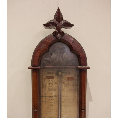 609 - A Victorian Gothic influence walnut cased Admiral Fitzroy barometer, late 19th century, the case sur... 