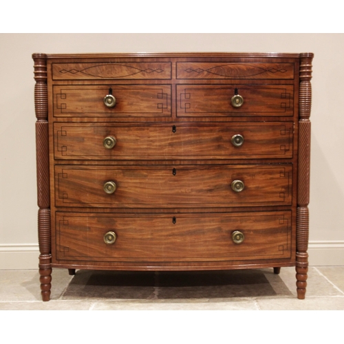 634 - A near pair of late George III mahogany bowfront chests of drawers, circa 1810, each chest with a cr... 