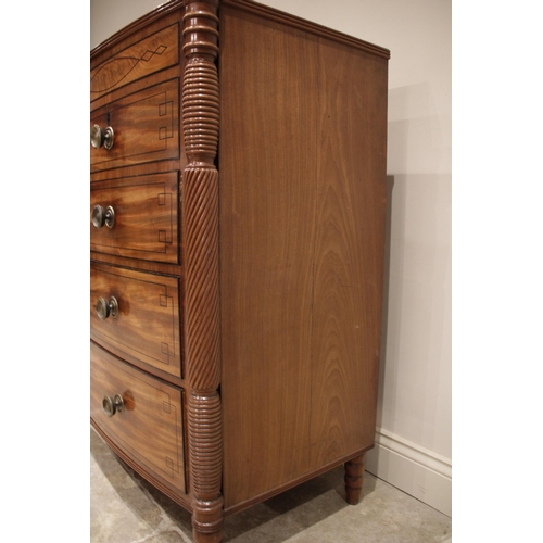 634 - A near pair of late George III mahogany bowfront chests of drawers, circa 1810, each chest with a cr... 