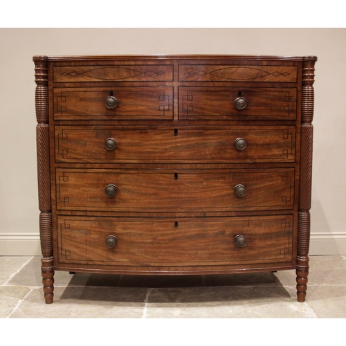 634 - A near pair of late George III mahogany bowfront chests of drawers, circa 1810, each chest with a cr... 