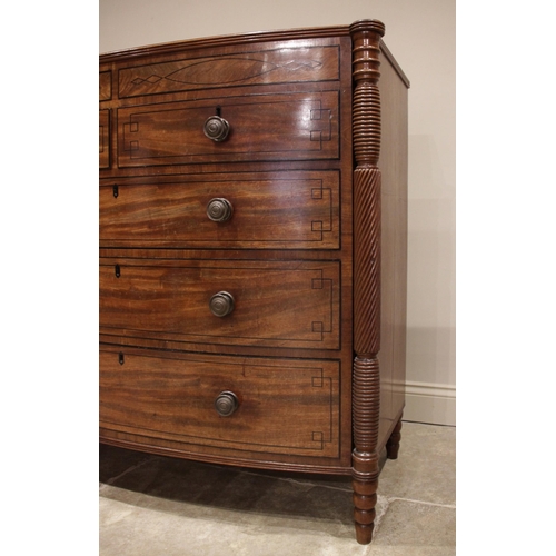 634 - A near pair of late George III mahogany bowfront chests of drawers, circa 1810, each chest with a cr... 