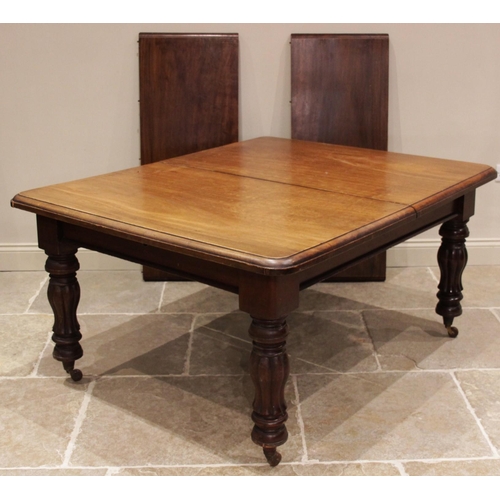 684 - A Victorian mahogany extending dining table, the rectangular moulded top with rounded corners, upon ... 