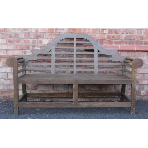 708 - A Lutyens type painted hardwood bench, late 20th century, the typical arched back uniting scrolled a... 