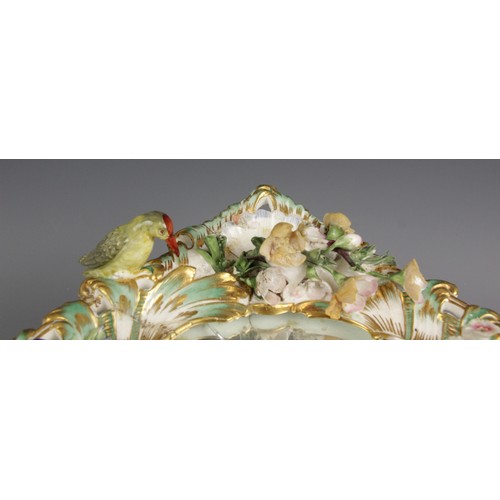 471 - A Rococo style porcelain florally encrusted mirror, late 19th century, the trefoil scroll and foliat... 