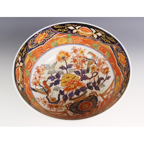 431 - A large Japanese Imari porcelain punch bowl, Meiji Period (1868-1912), of circular form and profusel... 