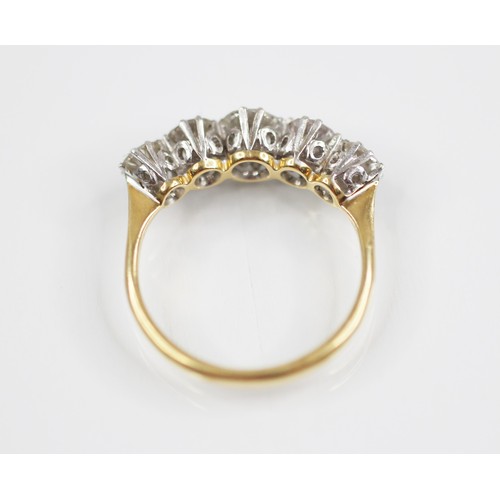 188 - An early 20th century five stone diamond ring, the central round brilliant cut diamond measuring 4.7... 