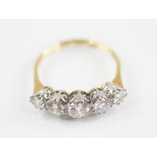 188 - An early 20th century five stone diamond ring, the central round brilliant cut diamond measuring 4.7... 