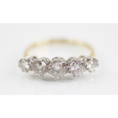 188 - An early 20th century five stone diamond ring, the central round brilliant cut diamond measuring 4.7... 