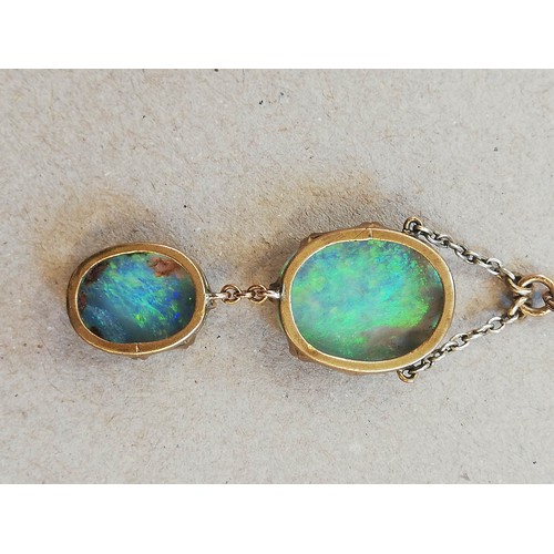 224 - An early 20th century black opal pendant, designed as an oval opal cabochon measuring 17.0mm x 14.0m... 