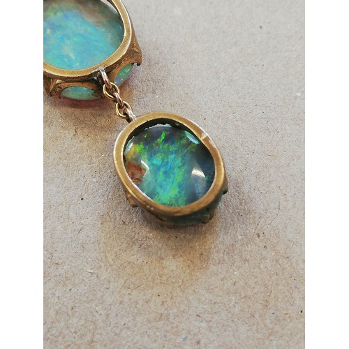 224 - An early 20th century black opal pendant, designed as an oval opal cabochon measuring 17.0mm x 14.0m... 