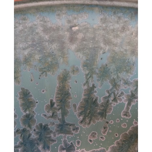 509 - A studio pottery bowl, 20th century, of shallow flared form with rolled rim, the celadon green groun... 