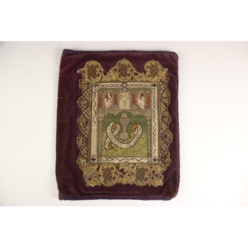 558 - An embroidered and applique bible cover, 18th century and later, depicting the sacrament beneath ang... 