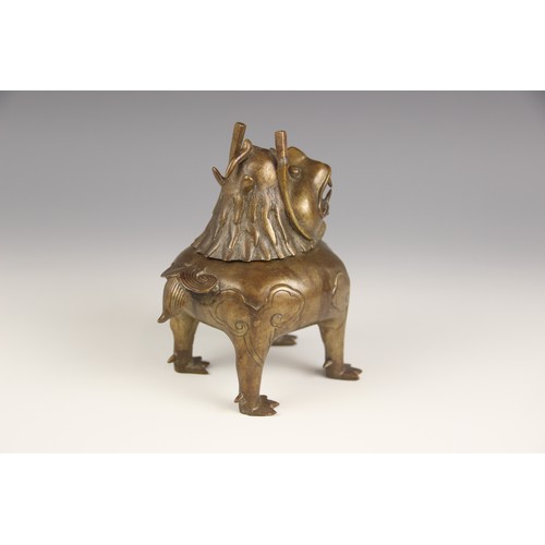 404 - A Chinese bronze 'Luduan' incense burner, modelled standing on four legs with hinged head forming th... 