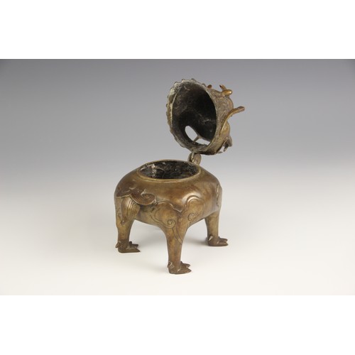 404 - A Chinese bronze 'Luduan' incense burner, modelled standing on four legs with hinged head forming th... 