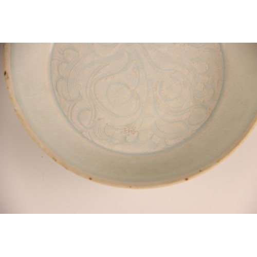 380 - A Chinese Qingbai 'flower' dish, Song Dynasty, the circular dish with incised floral motifs enclosed... 