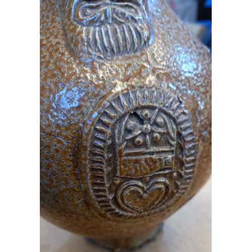 438 - A 17th century Armorial bellarmine jug, the salt glazed stoneware jug of typical swollen form and ap... 