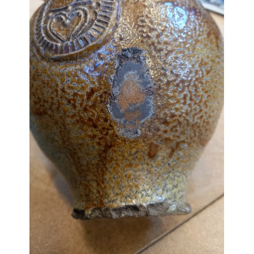 438 - A 17th century Armorial bellarmine jug, the salt glazed stoneware jug of typical swollen form and ap... 