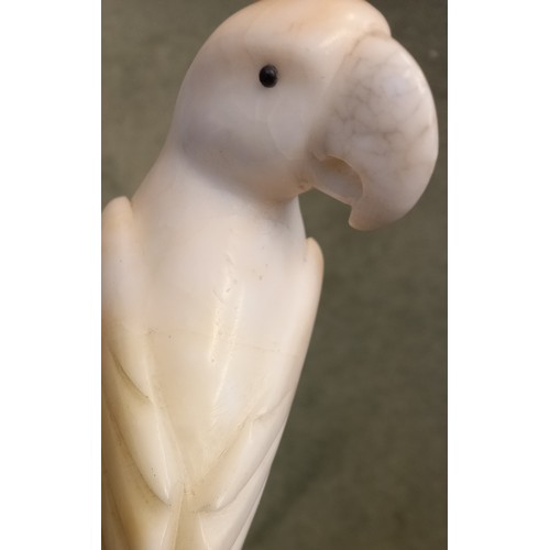 251 - An Art Deco style carved alabaster model of a parrot, circa 1930, modelled upon a perch, 22.5cm high