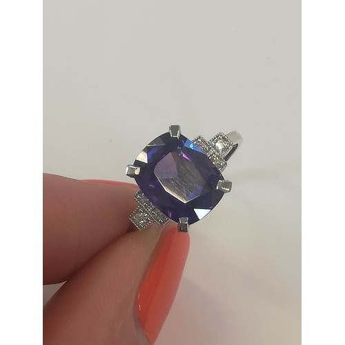 207 - A colour-change sapphire and diamond ring, the rectangular cushion mixed cut sapphire weighing 4.20 ... 