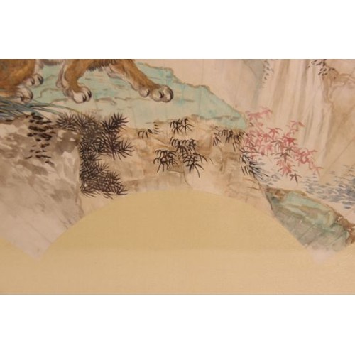 399 - Chinese School (20th century), watercolour laid on silk fan painting, depicting a lion on a rocky ou... 