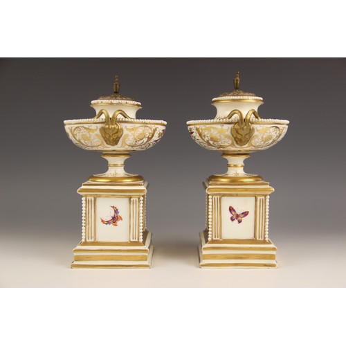 447 - A pair of Paris porcelain pot pouri, 19th century, each modelled as a hemispherical urn on square pl... 