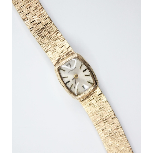 130 - A ladies 9ct gold Tudor wristwatch, the tonneau shaped dial with baton markers and Tudor emblem to t... 