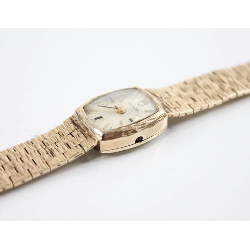 130 - A ladies 9ct gold Tudor wristwatch, the tonneau shaped dial with baton markers and Tudor emblem to t... 