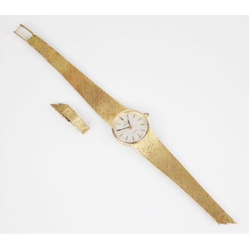 132 - A 9ct gold ladies Omega wristwatch, the central circular white dial with baton markers, set to a pla... 