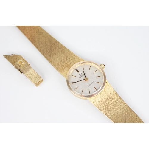 132 - A 9ct gold ladies Omega wristwatch, the central circular white dial with baton markers, set to a pla... 