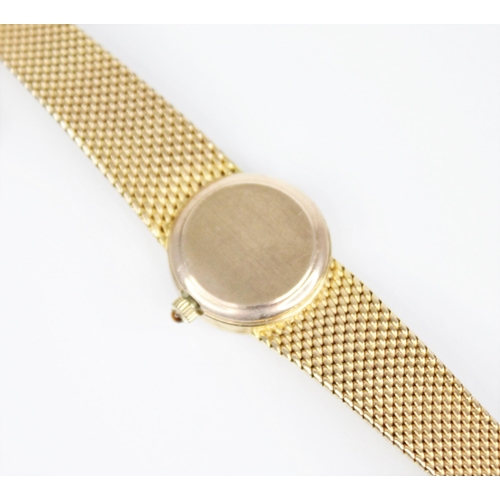 132 - A 9ct gold ladies Omega wristwatch, the central circular white dial with baton markers, set to a pla... 