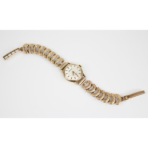 143 - A ladies Accurist 9ct gold wristwatch, the circular  dial with baton markers, set to a plain polishe... 