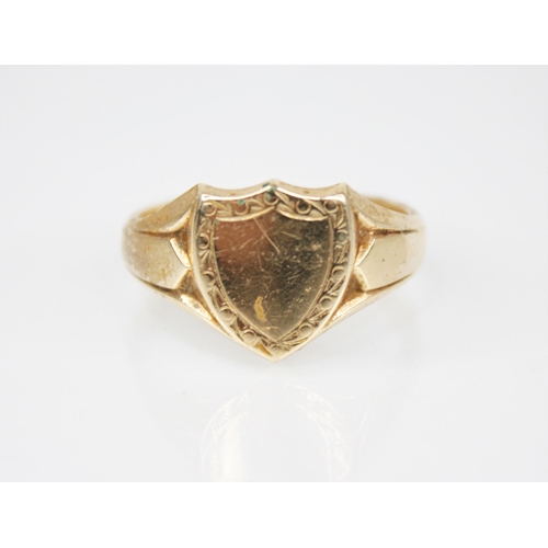 162 - A 9ct gold signet ring, of shield form with tapering shoulders and plain polished band, marks for 'G... 