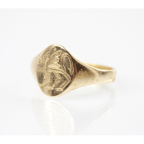 163 - A 9ct gold signet ring, the central oval cartouche depicting a Welsh dragon, leading to tapered shou... 