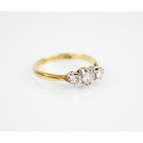 169 - An early 20th century three stone diamond ring, the central round transitional cut circular diamond ... 