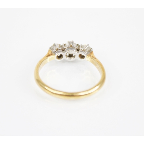 169 - An early 20th century three stone diamond ring, the central round transitional cut circular diamond ... 