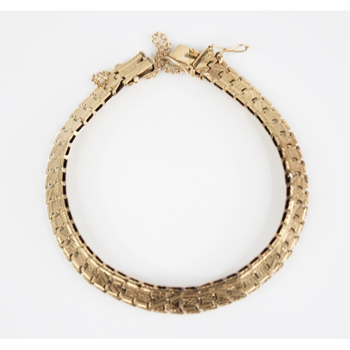 174 - A yellow metal bracelet by Smith & Pepper, the brick link chain with engraved foliate detail,  tongu... 