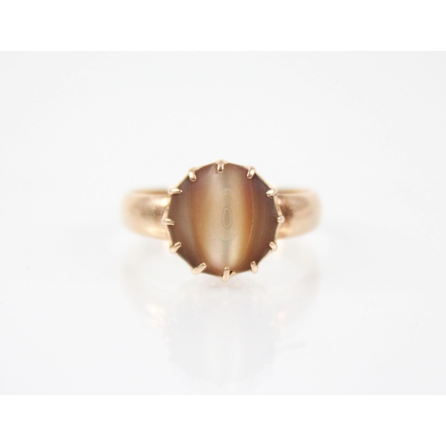 179 - An early 20th century gold coloured shell set ring, the central circular shell panel measuring 12mm ... 