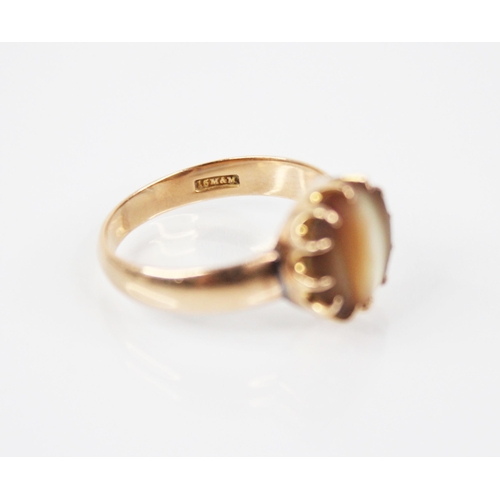 179 - An early 20th century gold coloured shell set ring, the central circular shell panel measuring 12mm ... 