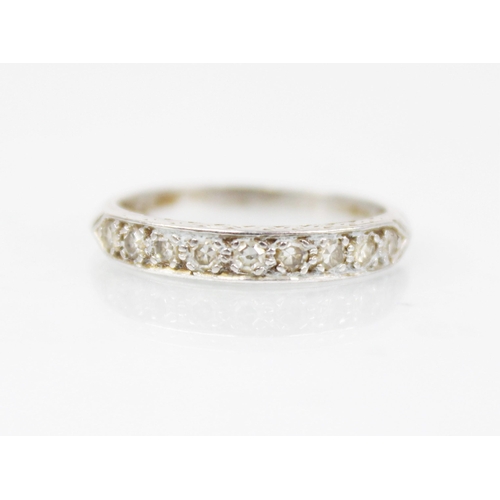 192 - A mid-20th century diamond half eternity ring, with nine round mixed cut diamonds set in a white met... 