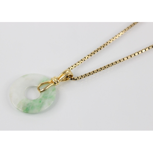 195 - A jade bi-disc pendant, the circular plain polished disc with rope form pendant bale, marked '18k', ... 