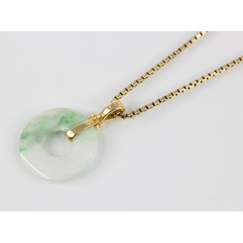 195 - A jade bi-disc pendant, the circular plain polished disc with rope form pendant bale, marked '18k', ... 