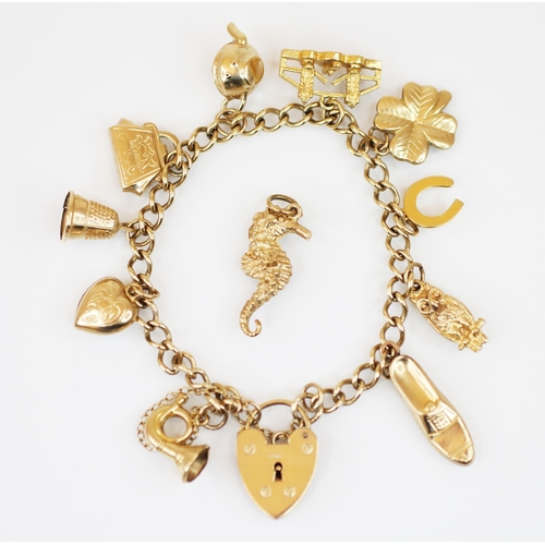 208 - A 9ct gold charm bracelet, the curb link bracelet, length 16cm, suspending an Edwardian heart shaped... 