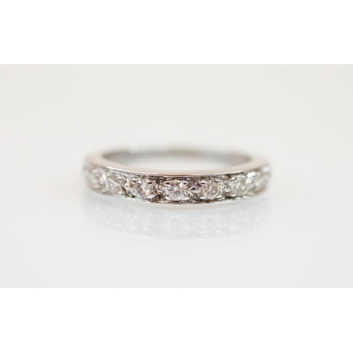 211 - A diamond set 18ct white gold half eternity ring, the nine round cut diamonds, measuring between 1.7... 