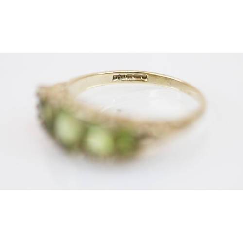 228 - A 9ct gold peridot five stone ring, the ring with central oval mixed cut peridot measuring 6.48 x 4.... 