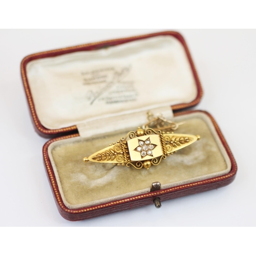 236 - A Victorian diamond set 15ct yellow gold brooch, the central raised lozenge with central flower head... 